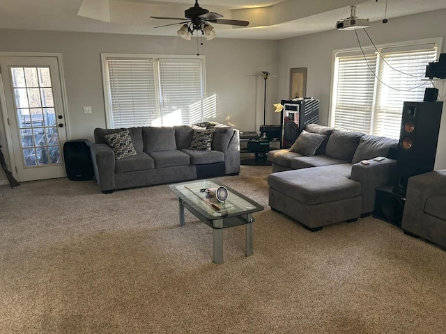 living room with ceiling fan and carpet