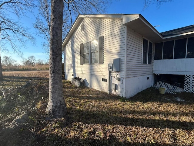 view of property exterior with a sunroom