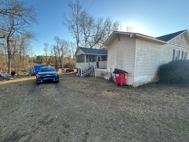 view of side of property featuring a sunroom