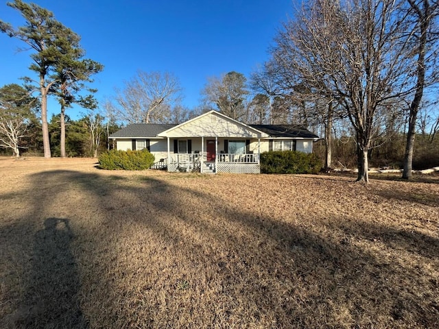 ranch-style home with a porch and a front lawn