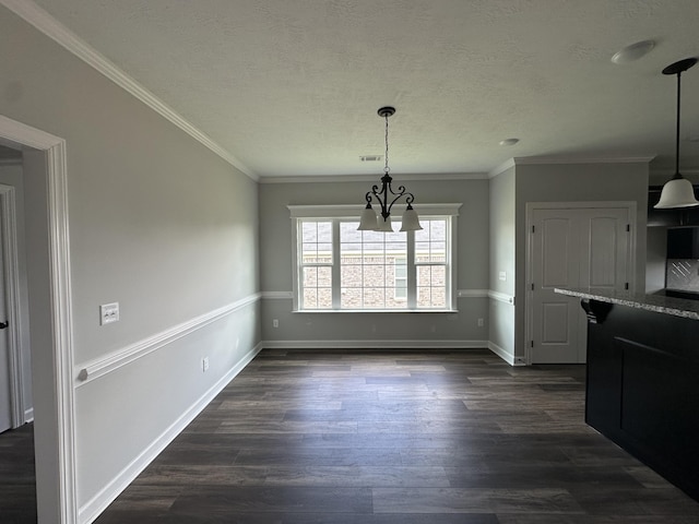 3351 Stockport Dr, Hephzibah, GA 30815 - unfurnished dining area featuring a chandelier, dark wood finished floors, baseboards, a textured ceiling, and ornamental molding