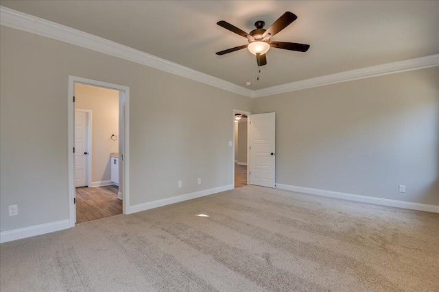 empty room featuring light carpet, ornamental molding, and ceiling fan