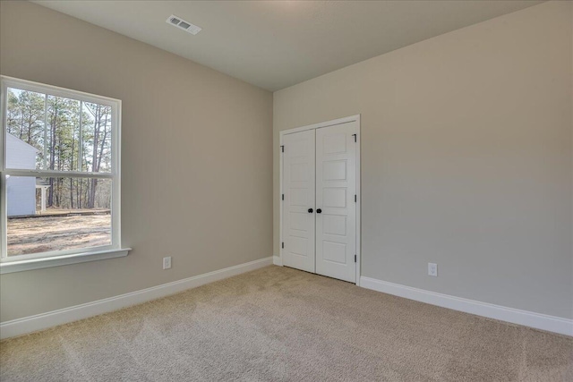 empty room with light colored carpet