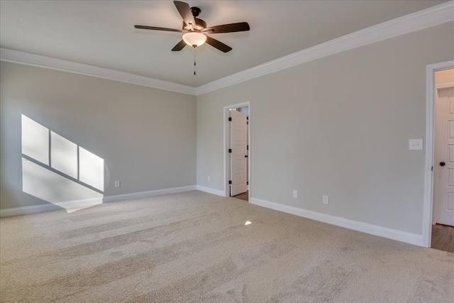 carpeted empty room featuring ornamental molding and ceiling fan