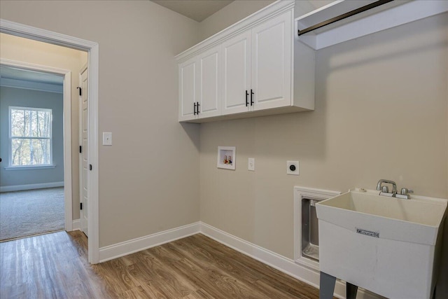 washroom with sink, cabinets, light hardwood / wood-style flooring, washer hookup, and hookup for an electric dryer