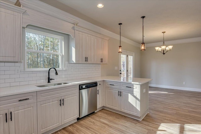 kitchen featuring tasteful backsplash, decorative light fixtures, light wood-type flooring, kitchen peninsula, and dishwasher