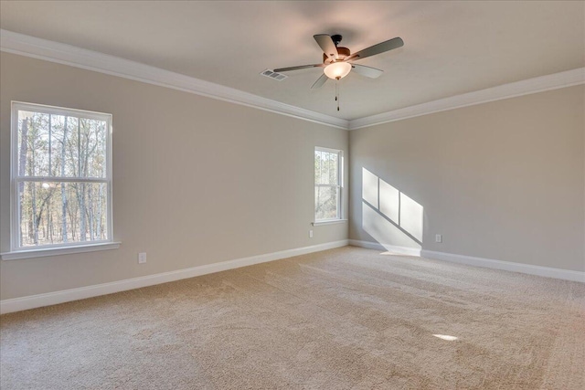 carpeted spare room featuring crown molding and ceiling fan