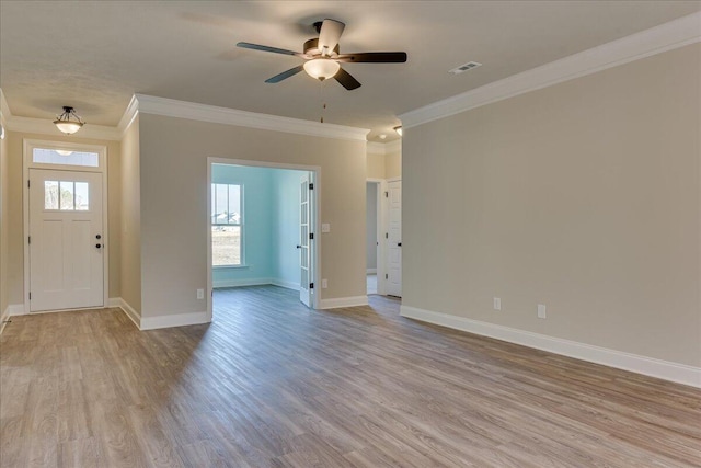 entrance foyer with light hardwood / wood-style flooring, ornamental molding, and ceiling fan