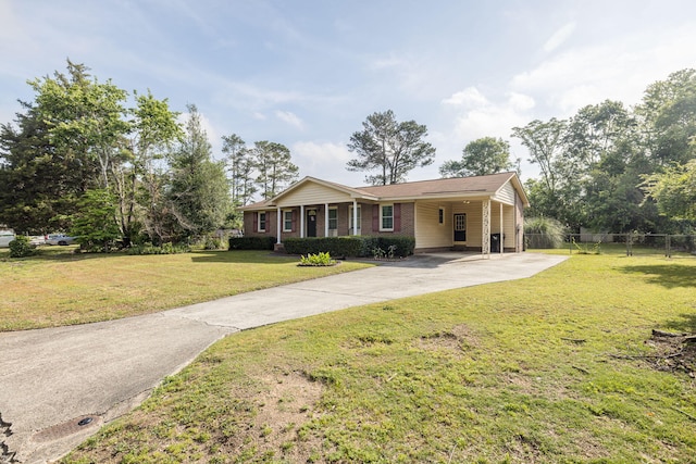 single story home with driveway, a front yard, a carport, brick siding, and fence