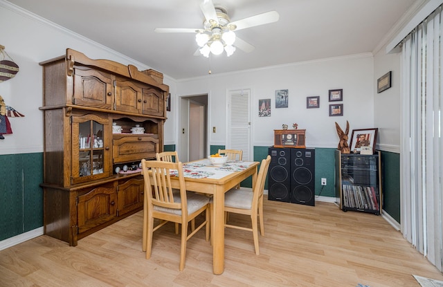 dining room with crown molding, a ceiling fan, and light wood finished floors
