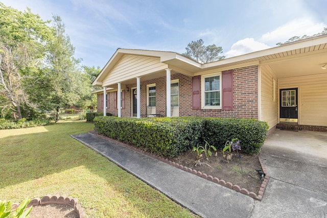 view of property exterior featuring a lawn and brick siding