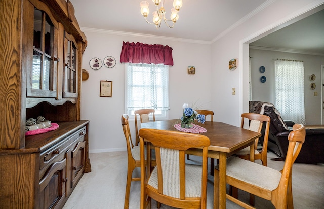 dining area featuring crown molding, baseboards, a chandelier, and light carpet