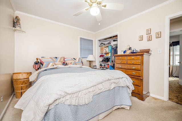 bedroom featuring ceiling fan, light colored carpet, baseboards, a closet, and ornamental molding