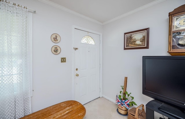 foyer entrance with baseboards, ornamental molding, and light carpet