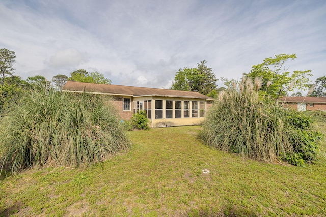 rear view of house with a lawn