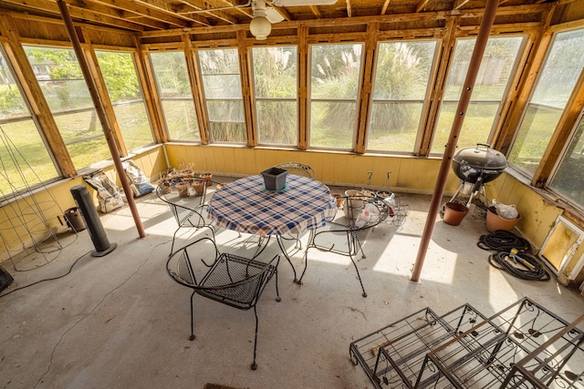 sunroom / solarium with a healthy amount of sunlight and outdoor dining space