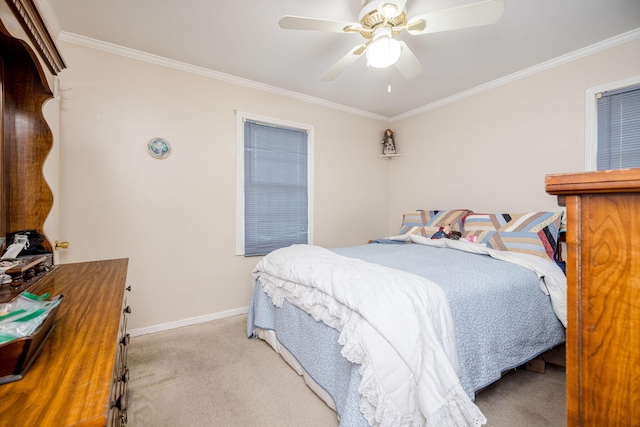 bedroom featuring crown molding, a ceiling fan, baseboards, and light colored carpet