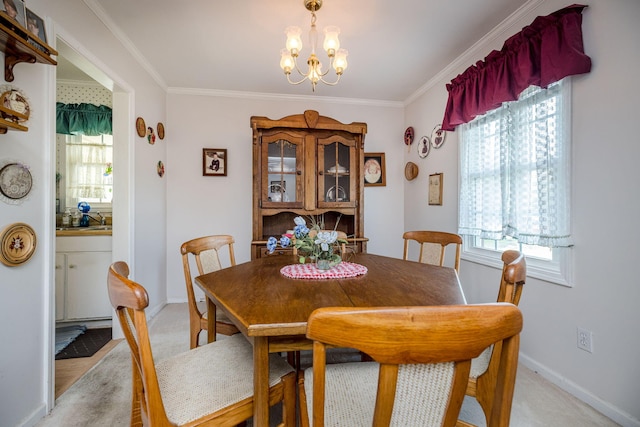 dining space featuring a healthy amount of sunlight, crown molding, and a chandelier