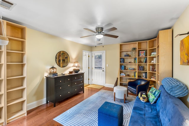 living area featuring ceiling fan and hardwood / wood-style floors