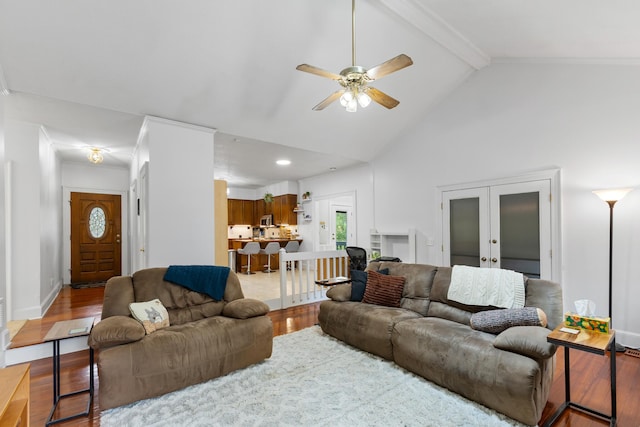 living room featuring high vaulted ceiling, french doors, hardwood / wood-style flooring, ceiling fan, and beam ceiling