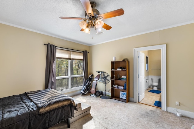 carpeted bedroom with a textured ceiling, connected bathroom, ceiling fan, and crown molding