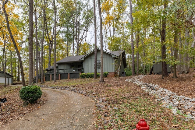 view of property exterior featuring an outbuilding and a wooden deck