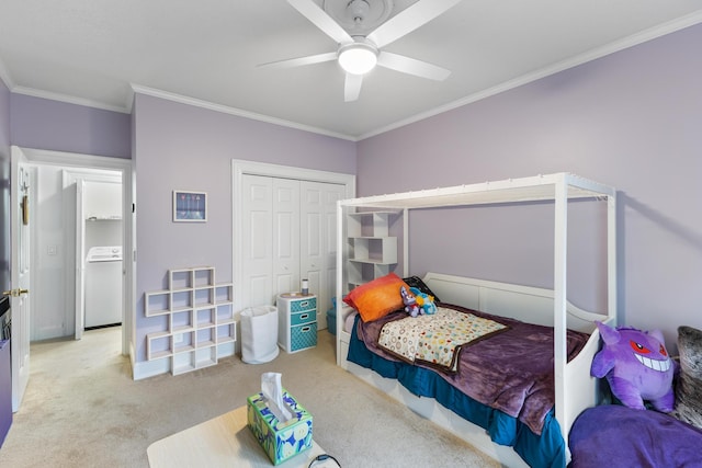 bedroom featuring light colored carpet, ceiling fan, crown molding, washer / dryer, and a closet