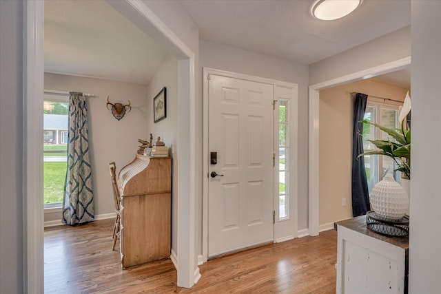 entrance foyer with baseboards and light wood-type flooring