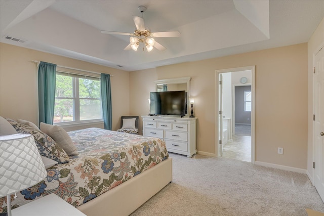 bedroom with baseboards, visible vents, a ceiling fan, and light carpet