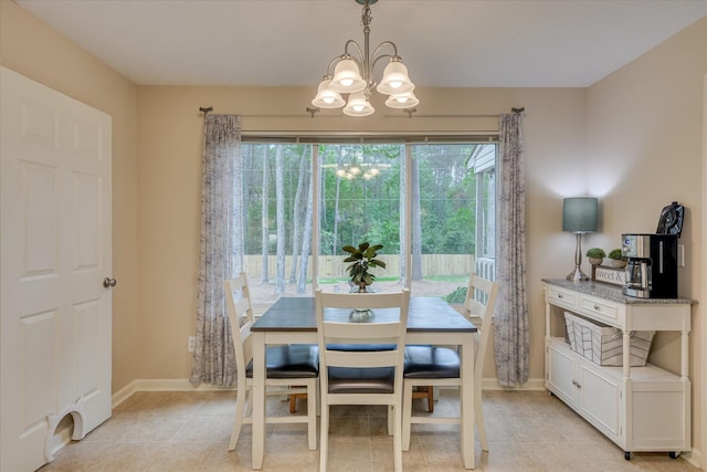 dining area with light tile patterned floors, a chandelier, and baseboards