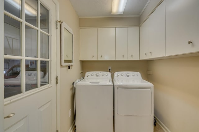 laundry area with baseboards, washer and dryer, and cabinet space