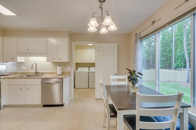 kitchen featuring a healthy amount of sunlight, stainless steel dishwasher, separate washer and dryer, and a sink