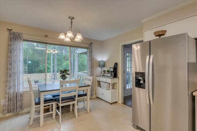 dining area with a wealth of natural light and a notable chandelier