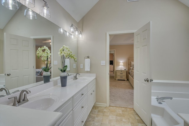 ensuite bathroom with ensuite bath, vaulted ceiling, and a sink