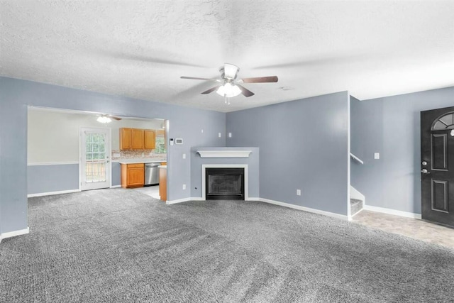 2409 Par Dr, Augusta, GA 30906 - unfurnished living room featuring a fireplace, carpet, stairs, a ceiling fan, and baseboards