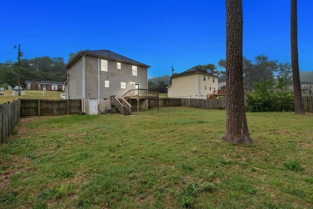 2409 Par Dr, Augusta, GA 30906 - view of yard featuring stairway, a wooden deck, and a fenced backyard