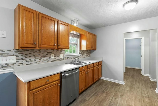 2409 Par Dr, Augusta, GA 30906 - kitchen featuring backsplash, a textured ceiling, stainless steel dishwasher, wood finished floors, and a sink