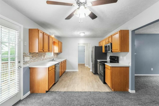 2409 Par Dr, Augusta, GA 30906 - kitchen featuring light countertops, a ceiling fan, baseboards, and appliances with stainless steel finishes