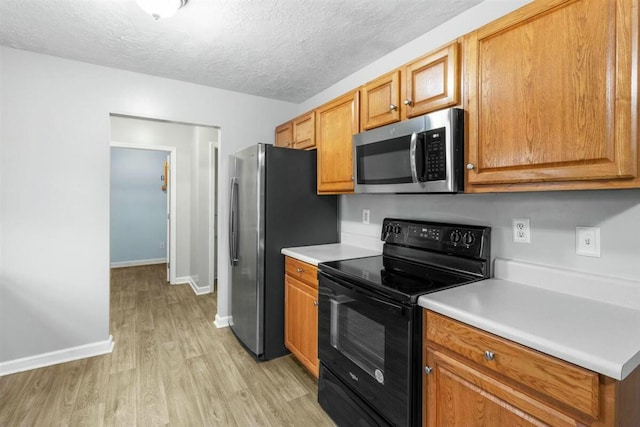 2409 Par Dr, Augusta, GA 30906 - kitchen with light wood-style floors, light countertops, baseboards, and appliances with stainless steel finishes