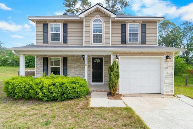 2409 Par Dr, Augusta, GA 30906 - traditional-style house featuring covered porch, a front yard, a garage, concrete driveway, and stone siding