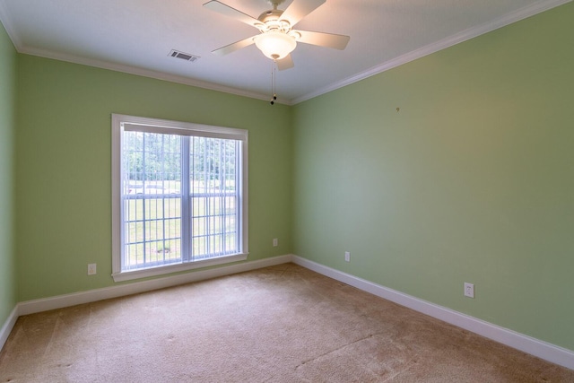 219 Devonshire Dr, Thomson, GA 30824 - spare room featuring carpet, healthy amount of natural light, crown molding, a ceiling fan, and baseboards