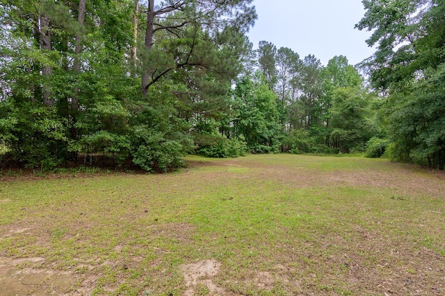 219 Devonshire Dr, Thomson, GA 30824 - view of grassy yard with a forest view