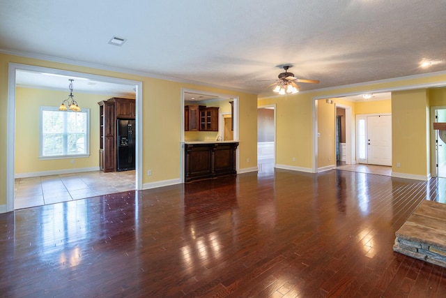 219 Devonshire Dr, Thomson, GA 30824 - unfurnished living room featuring ceiling fan, wood-type flooring, a chandelier, ornamental molding, and baseboards
