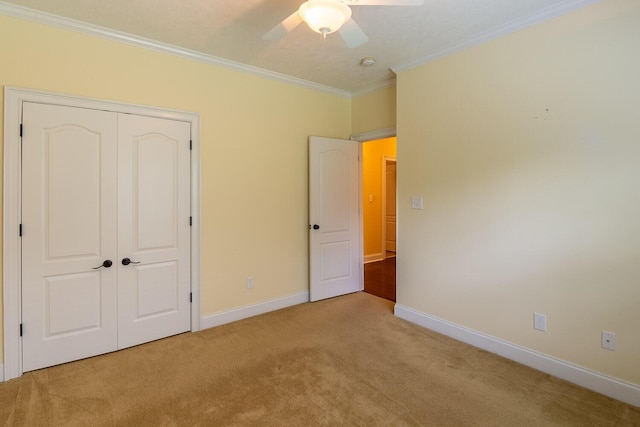 219 Devonshire Dr, Thomson, GA 30824 - unfurnished bedroom featuring light carpet, ornamental molding, a closet, baseboards, and ceiling fan