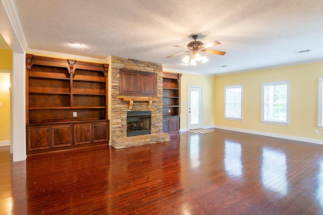 219 Devonshire Dr, Thomson, GA 30824 - unfurnished living room featuring crown molding, ceiling fan, baseboards, a stone fireplace, and dark wood-type flooring