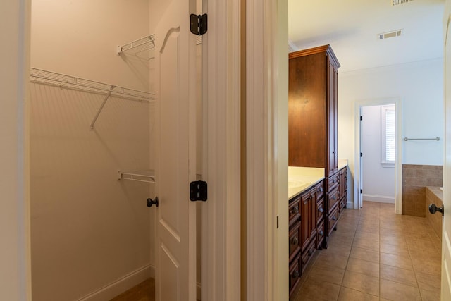 219 Devonshire Dr, Thomson, GA 30824 - full bath featuring vanity, a spacious closet, tile patterned floors, and baseboards