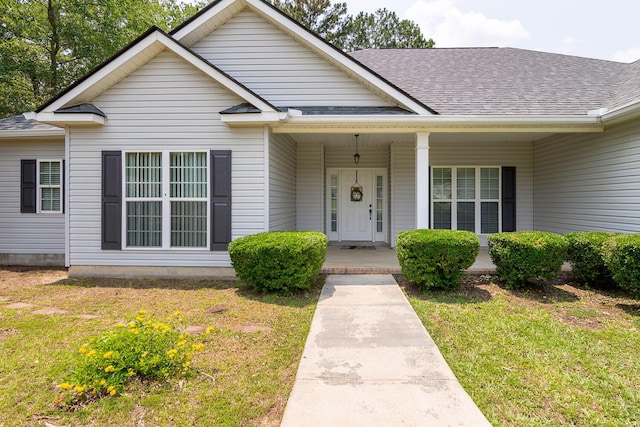 219 Devonshire Dr, Thomson, GA 30824 - bungalow-style home with a shingled roof, a front yard, and covered porch