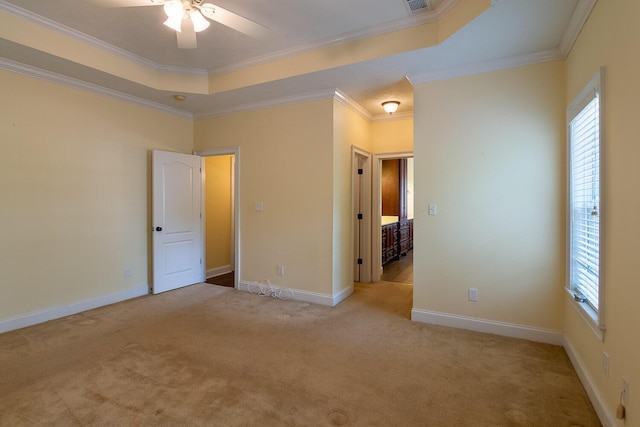 219 Devonshire Dr, Thomson, GA 30824 - unfurnished bedroom with multiple windows, carpet floors, crown molding, a raised ceiling, and baseboards