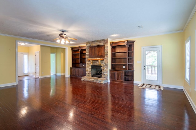 219 Devonshire Dr, Thomson, GA 30824 - unfurnished living room featuring a stone fireplace, crown molding, ceiling fan, baseboards, and wood finished floors