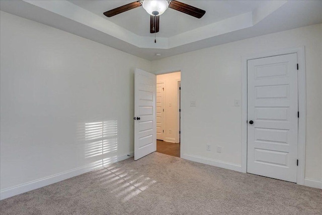 818 Fenwick Ct, Grovetown, GA 30813 - unfurnished bedroom with carpet flooring, a raised ceiling, baseboards, and a ceiling fan